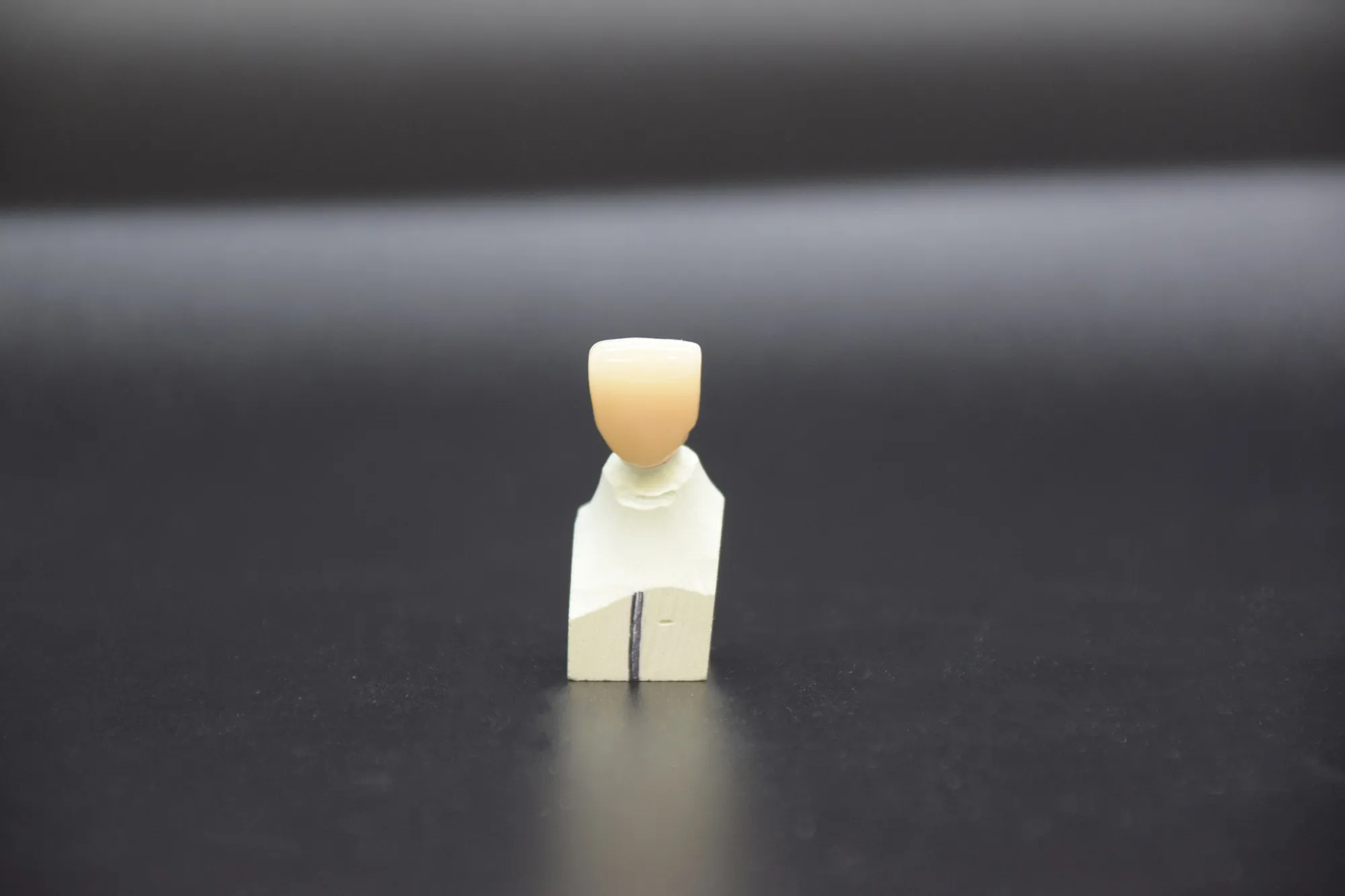 Finished zirconia crown produced from an approved CAD design
